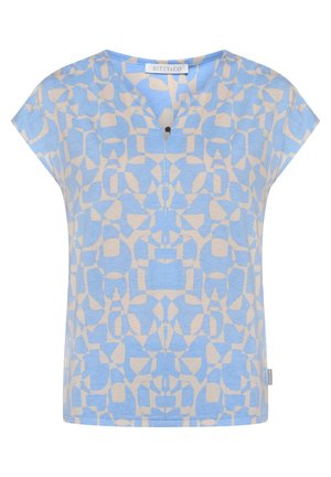 Kortademige blauwe en beige top met geometrisch patroon, V-hals en een kleine zwarte knoop bij de halslijn.