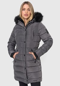 Gray padded coat featuring a faux fur-trimmed hood, zippered pockets, and ribbed cuffs. Straight cut with horizontal stitching detail.
