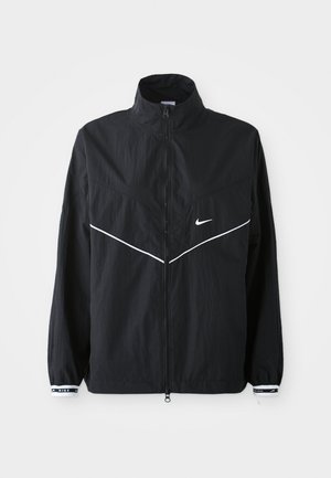 Must teine must windbreaker jakk kõrge kraega, täispikk tõmblukk, valged aktsentjooned ja logo. Omab elastseid mansette, millel on kontrastne äär. Kerge materjal.