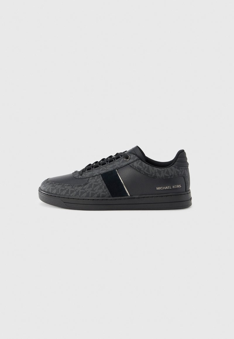 Black sneakers with a patterned textile upper, leather accents, flat laces, and a durable rubber sole. Brand name displayed on the heel.