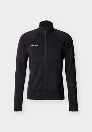 Mustast täisosaga lukuga fliisjope kõrge kraega, pikkade varrukatega, küljetaskutega, millel valge "Mammut" logo rinnal ja varrukal.