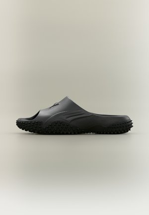 Puma MOSTRO SLIDE UNISEX - Strandpapucsok és -szandálok - black