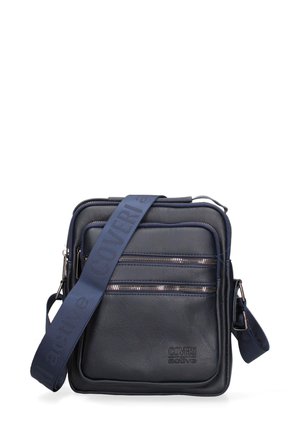 Petit sac bandoulière noir avec deux poches zippées horizontales, bandoulière réglable bleu marine marquée « Coveri active » et panneau avant texturé.
