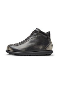 High-top leather shoe in black with a textured finish, featuring laces, rounded toe, and a thick rubber sole with traction.