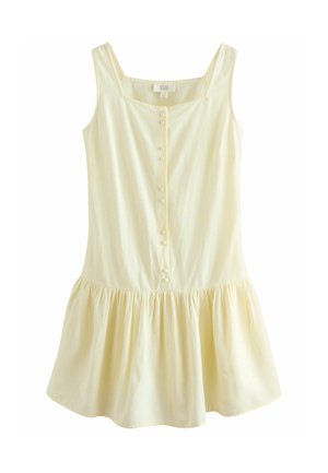 Gaiši dzeltena saulē nēsāma kleita ar kvadrātu formas dekoltē, pogu priekšu un savāktā plīvojošā svārka. Izgatavota no mīkstas auduma ar gludu tekstūru.