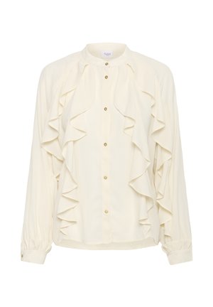 Kreminė palaidinė su raukšlėtu priekiu ir auksiniais mygtukais. Turėdama ilgas rankoves su susiraukšlėmis ir apvaliu apykakle. Lygus, lengvas audinys.