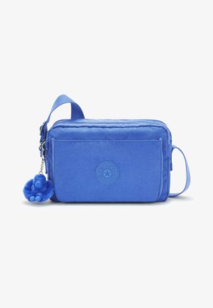 Blå stofpose med lynlåslukning, cirkulært logo og en lille blå abe-nøglering. Bog førers en bærehåndtag og en frontlomme.