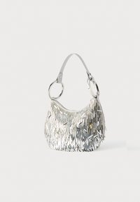 Geantă de mână cu franjuri argintii, cu formă curbată, suprafață texturată, o curea albă și accente mari circulare din metal. Oferă închidere cu fermoar.