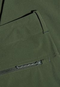 Dark green fabric with a smooth texture features a front pocket and a zippered pocket. Strengthened stitching along edges adds durability.