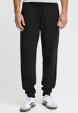 Sorte sweatpants med snor i taljen, ribbede manchetter og sidelommer, lavet af en blød bomuldsblanding. Har et logo-patch på låret.
