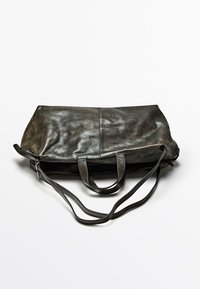 Leather tote bag, dark gray, rectangular shape. Soft texture, two top handles, adjustable shoulder strap, subtle sheen, no visible hardware.