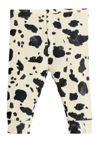 Leggings acanalados en crema con un estampado de vaca negro. Presentan una cinturilla y puños elásticos, con una pequeña etiqueta de logo en el dobladillo.