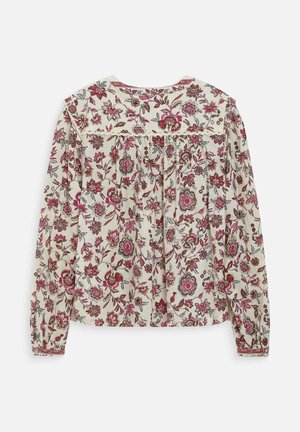 Blouse crème à manches longues avec imprimé floral rouge et rose, détail de plis froncés sur le haut du dos et poignets boutonnés.