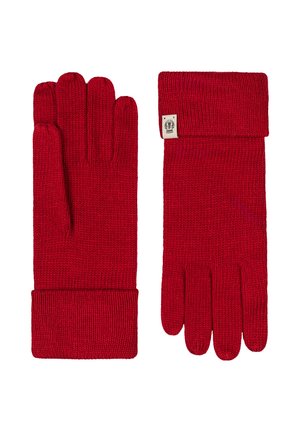 Paar rote gestrickte Handschuhe mit umgeschlagenen Bündchen, ein Handschuh mit der Handfläche nach oben, der andere mit der Handfläche nach unten, mit einem kleinen Stoffetikett am Bündchen.