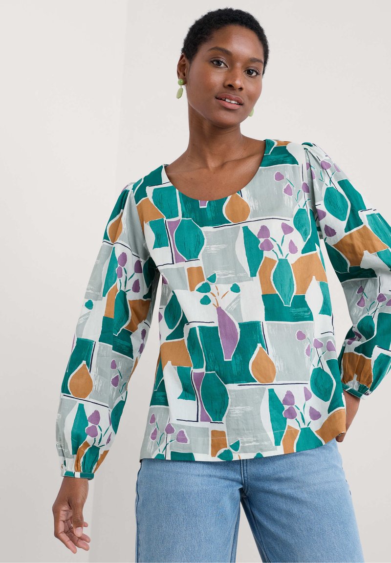 Blusa a maniche lunghe in tessuto leggero con un motivo astratto colorato di vasi e foglie in verde, marrone, viola e bianco.