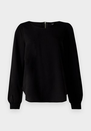 Svart langermet topp med rund halsutringning, strikkede mansjetter og detalj med glidelås bak, laget av et glatt stoff med en svak glans.
