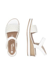 Sandales compensées blanches avec une lanière supérieure tressée, une lanière de cheville réglable et une semelle texturée. Présente un talon imitant le bois et une semelle intérieure rembourrée.