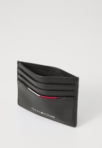 Black leather card holder with textured finish, featuring multiple card slots and a printed logo at the bottom. Slim and compact design.