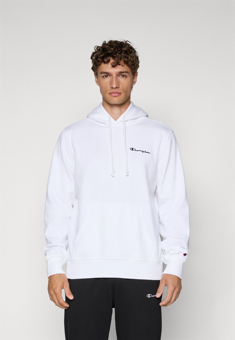 White hoodie with a front pocket, adjustable drawstrings, and a small black "Champion" logo on the chest. Fabric appears soft and smooth.