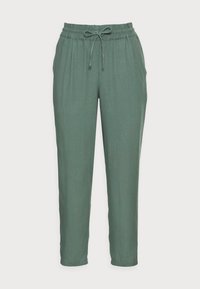 Pantalones verdes ajustados con cintura elástica y cordón ajustable. Textura suave, sin bolsillos, diseño hasta los tobillos.
