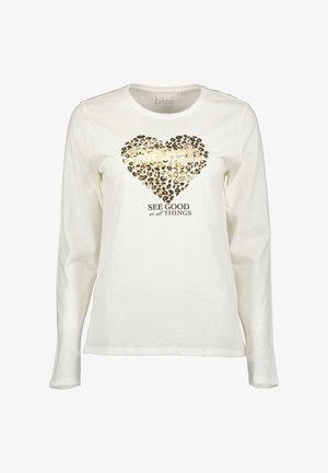 Witte longsleeve t-shirt met een luipaardprint hartmotief en gouden accenten, met de tekst "ZIE GOED in alle DINGEN" eronder.