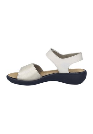 Open-toe sandals featuring a metallic silver front strap and white back strap, with a navy blue cushioned sole for comfort.