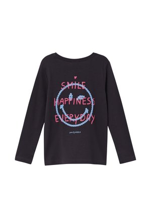 Chemise noire à manches longues avec un smiley en sequins bleus et un texte rose disant "Sourire Bonheur Chaque Jour" sur le devant.