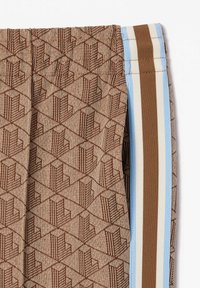 Brown patterned pants with a geometric texture, featuring side stripes in light blue and brown. The fabric is smooth with a fitted design.