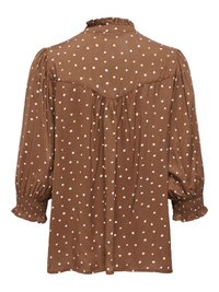 Blouse marron à pois blancs, poignets froncés, col à volants et détail plissé au dos.