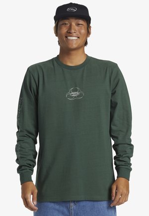 Green long-sleeve shirt made of cotton, featuring a central logo and decorative patterns on the sleeves. Material is smooth with a casual fit.