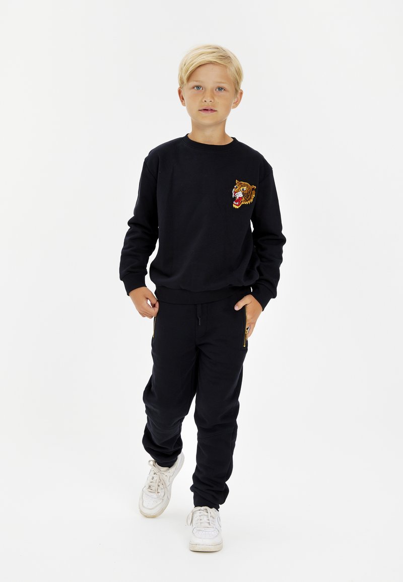 The New TNDEVON Tracksuit bottoms black Zalando.ie