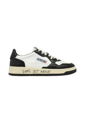 Sneaker basse in pelle bianca e nera, lacci bianchi, logo Autry con bandiera americana e testo "GAME SET MATCH!" sulla suola.
