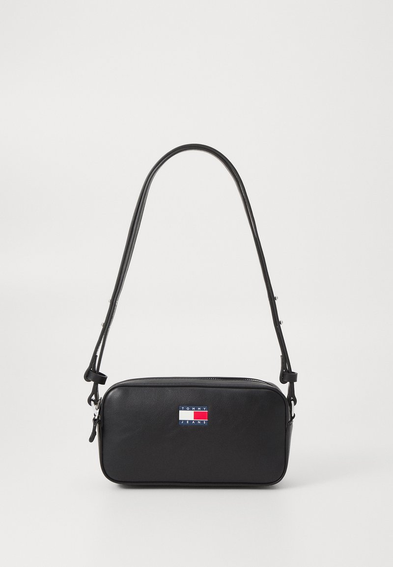 Black leather crossbody bag with a rectangular shape. Features a long adjustable strap and a colorful brand logo on the front. Smooth texture.