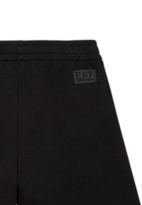 Pantaloni della tuta neri con vita elasticizzata, dotati di una piccola toppa con il logo EA7 sul retro. Realizzati in un morbido tessuto elasticizzato.