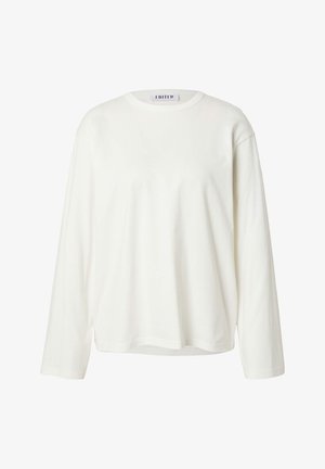 Schlichtes weißes Langarmshirt mit Rundhalsausschnitt, ohne sichtbare Muster oder Logos, mit dem Aufnäher "EDITED" am inneren Kragen.