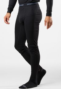 Schwarze thermische Leggings aus geripptem Stoff mit einem Swedemount-Logo-Bund, die eine schmale Passform und eine glatte Textur aufweisen.