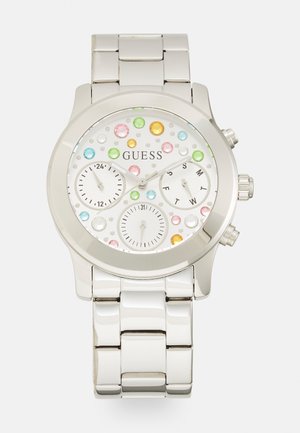 Montre en acier inoxydable argenté avec un cadran rond blanc, agrémenté de strass multicolores, de deux sous-cadrans et d'un bracelet poli.