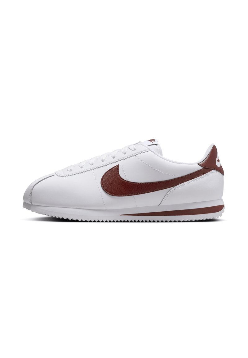 White leather sneakers with a brown swoosh, rounded toe, flat laces, and a textured rubber outsole. Simple design with low-profile silhouette.