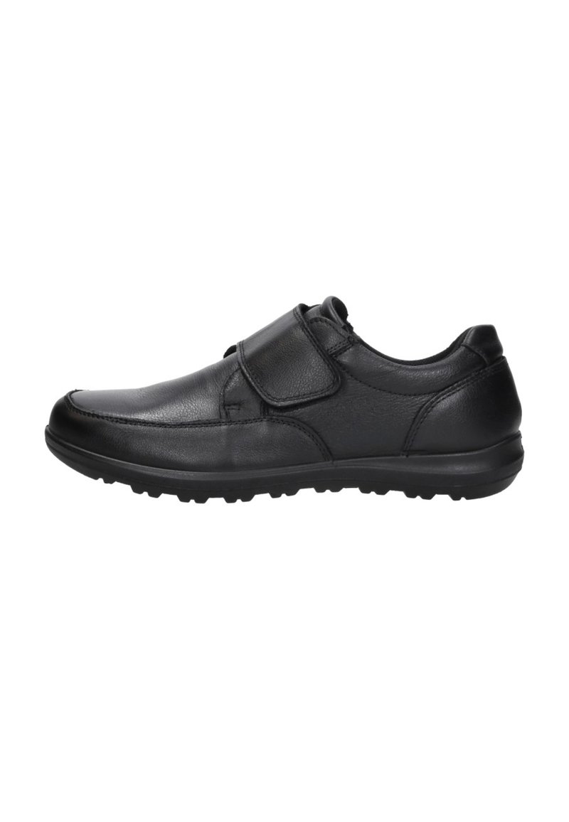 Zwarte leren schoen met een ronde neus, een klittenbandsluiting en een gestructureerde rubberen zool met grip.