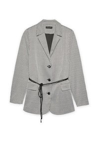 Mustat ja valkoiset houndstooth-kuvioiset bleiserit, joissa on läpät, kolme mustaa nappia, kaksi etutaskua ja ohut musta vyö sidottuna vyötärölle.