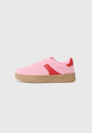 Pink sneakers with a red accent, featuring a low-top design, textured fabric, and a contrasting brown rubber sole.