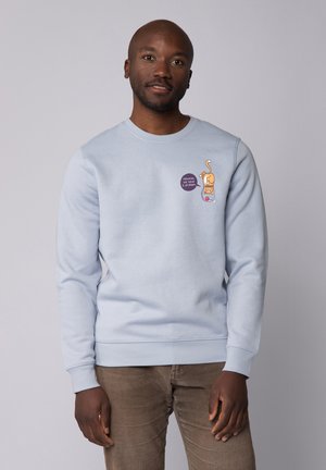 Lichtblauwe sweatshirt van katoen, met een illustratie van een kat en een circulair tekstdetail aan de voorkant. Lange mouwen en ronde hals.