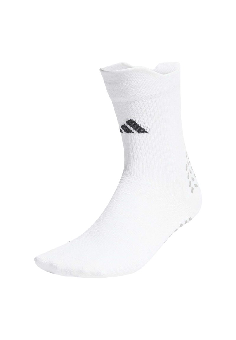 Weißer Sportsocke mit geripptem Design, ausgestattet mit einem grauen Logo und gepunktetem Muster auf der Sohle für besseren Halt. Knöchelhöhe mit glatter Textur.