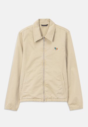 Veste zippée beige avec col pointu, deux poches avant, poignets et ourlet élastiques, et un petit cheval multicolore brodé sur la poitrine.