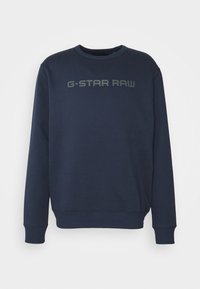 Mörkblå crewneck sweatshirts med långa ärmar och "G-STAR RAW" tryckt i grått över bröstet.