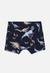 Bawełniane szorty z granatowym tłem ozdobione różnymi wzorami dinozaurów w jasnych kolorach. Elastyczny pas, gładka faktura, długość do kolan.