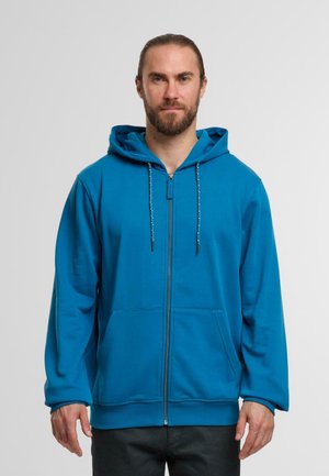 Niebieska bluza z kapturem zapinana na zamek, z regulowanym kapturem, przednimi kieszeniami, miękką teksturą i ściągaczami na rękawach. Zamek błyskawiczny sięga do kołnierza. Prosty design.