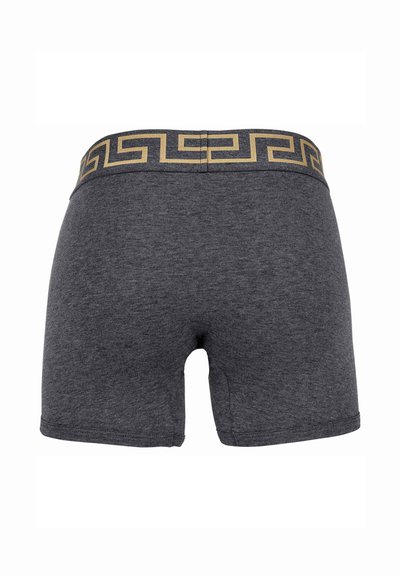 Dark gray boxer shorts with a soft texture. Features a patterned black and gold elastic waistband with a Greek key design.