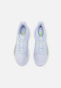 Light blue athletic shoes with a textured mesh upper, reflective accents, and neon green detailing on the tongue and side panels.
