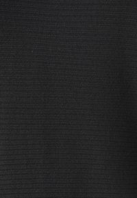 Tissu noir texturé avec un motif en relief, surface lisse et couleur uniforme. Convient à diverses applications vestimentaires.